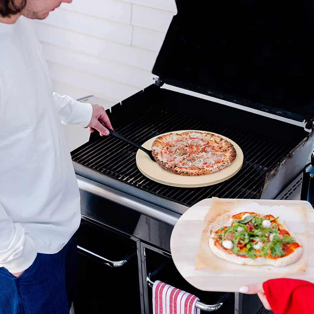 A pitmaster using the CastElegance Thermarite grilling stone to cook pizza