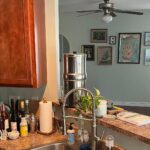 He kept his orange cabinets and sage walls: the white-and-gray makeover looks like a full rebuild