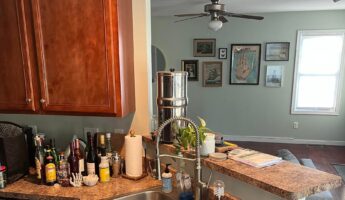 He kept his orange cabinets and sage walls: the white-and-gray makeover looks like a full rebuild