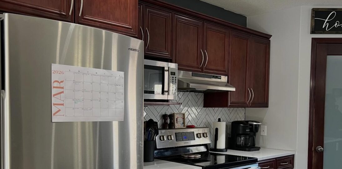 She sprayed cherry cabinets Chantilly Lace with Sherwin-Williams Gallery Series: same navy island, new kitchen