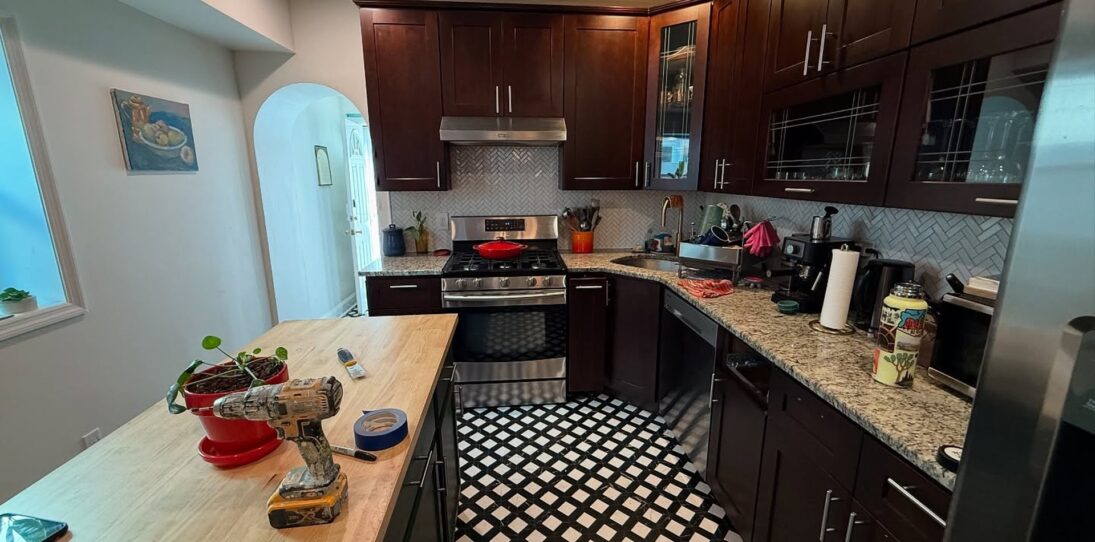 He sprayed dark cherry cabinets Benjamin Moore Rosepine: same checkered floor, now the kitchen looks custom