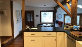 They replaced white Shaker cabinets with Hale Navy and marble: now the exposed-beam kitchen looks custom