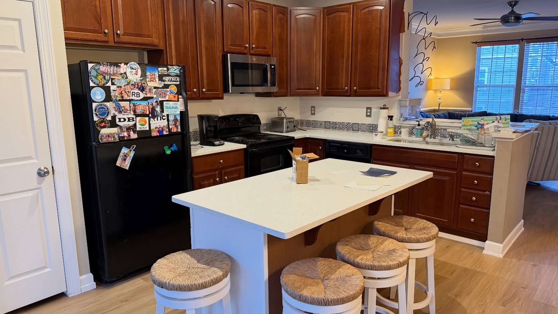 They painted cherry cabinets Sherwin-Williams Pure White and the island Indigo B...