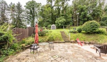 Everyone saw a bad slope and ruined patio: she kept both and turned the yard into a lush, resort-like retreat